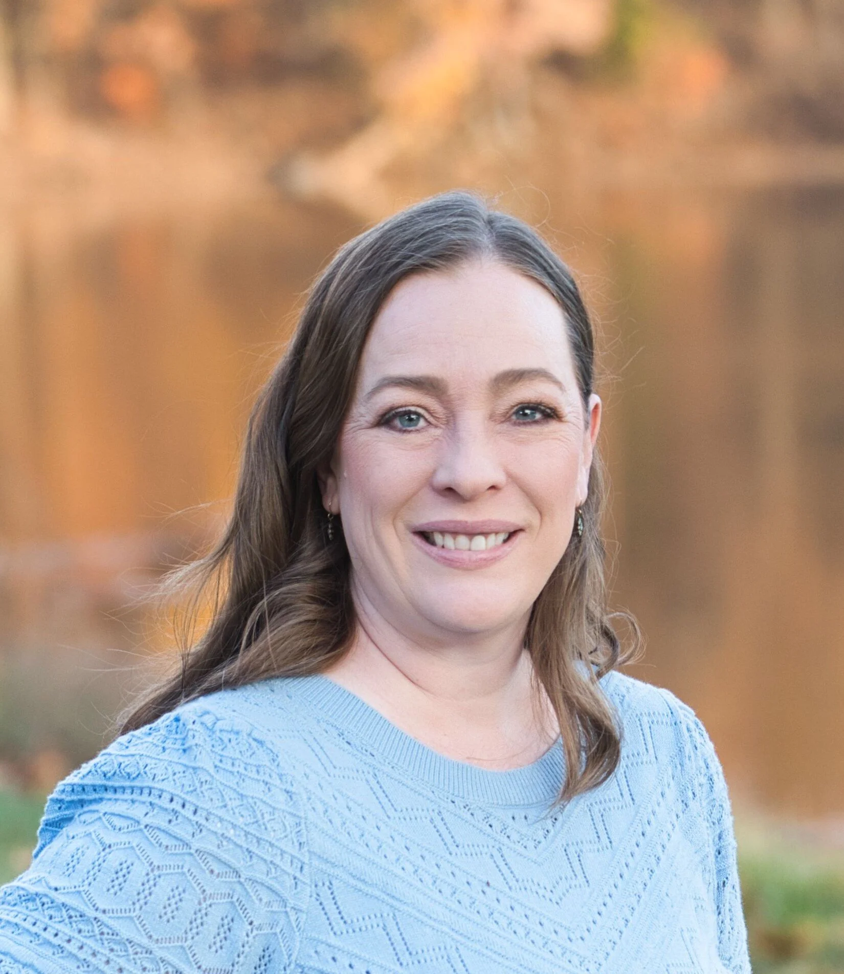 Kansas City caregiver enjoying a peaceful outdoor moment in summer with newborn