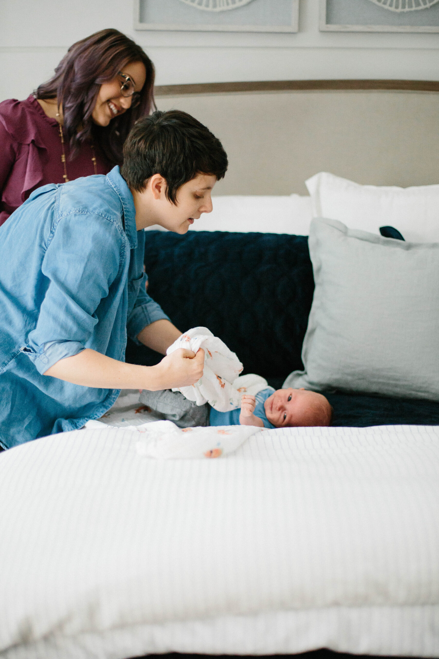 caregiver gently dressing newborn after successful bottle feeding session