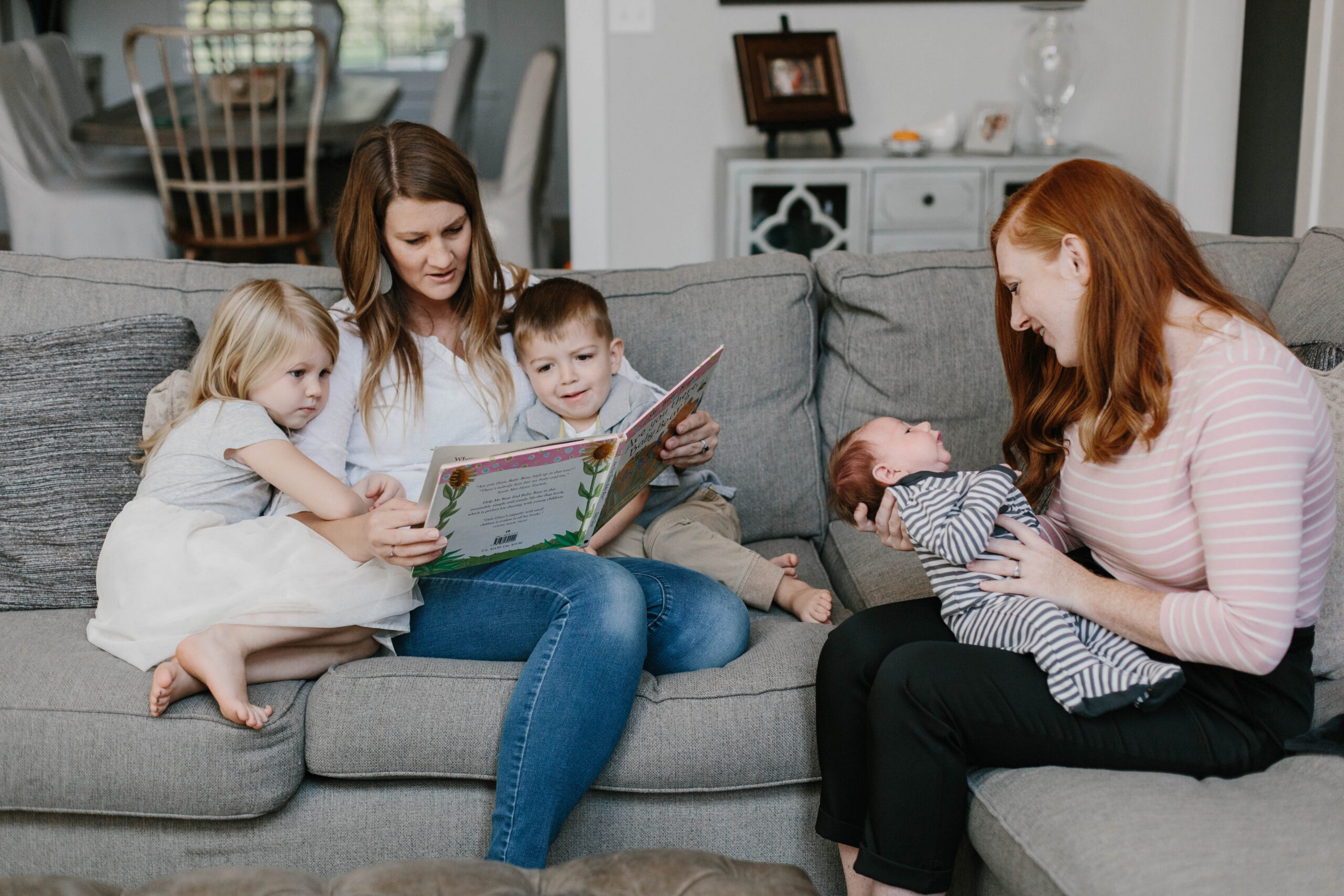 family reading together with newborn during supported postpartum period