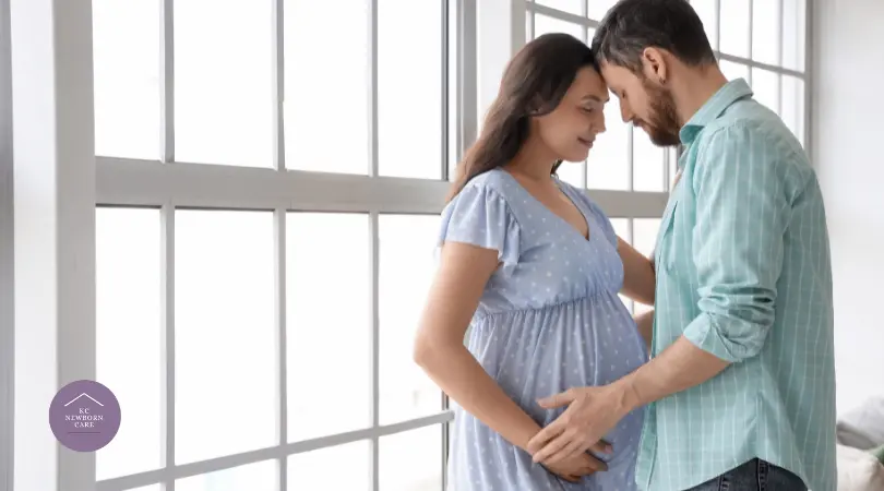 Expectant father gently supporting pregnant partner during the postpartum preparation stage