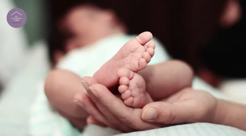 caregiver gently cradling newborn feet demonstrating Dunstan Baby Language attentive care