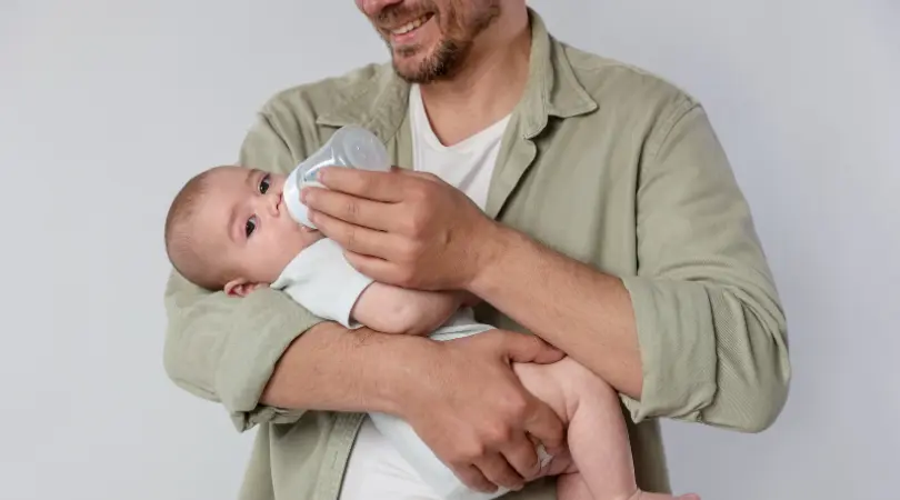 bottle of pumped breast milk ready for newborn feeding